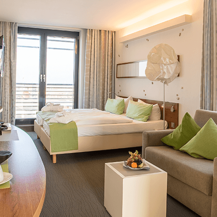 View of a comfortable sofa and double bed