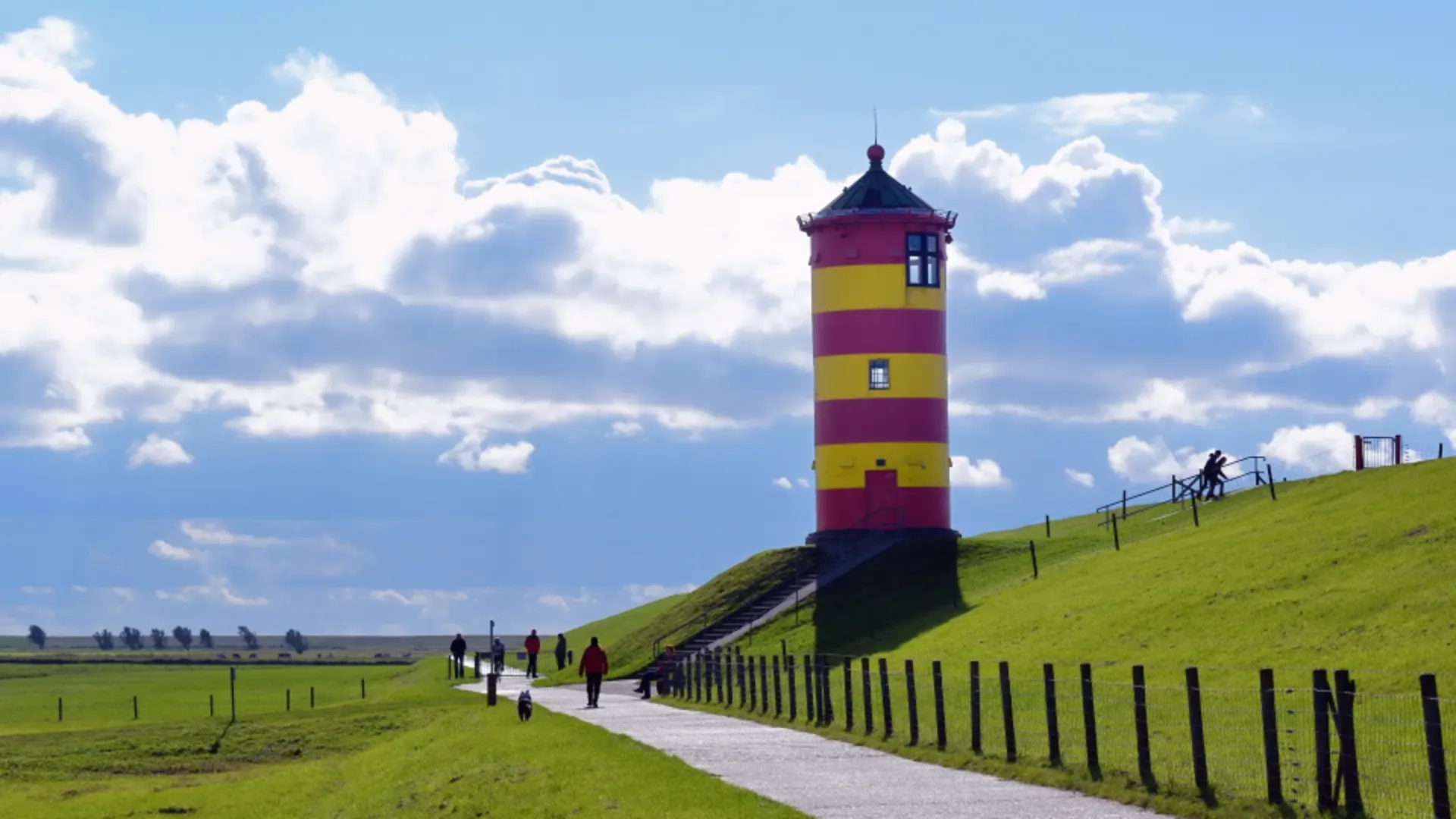 Green Dyke with Yellow and Red Striped Lighthouse