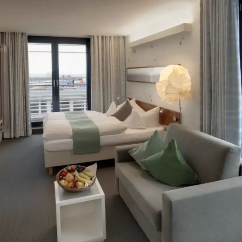 View of a comfortable sofa and double bed